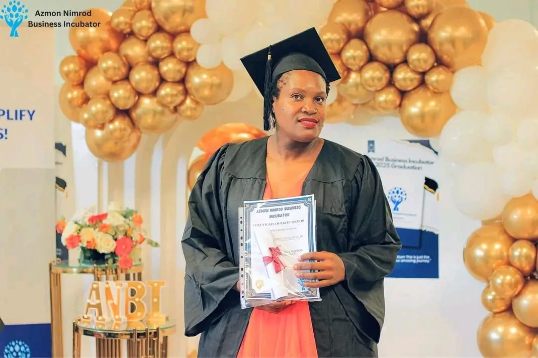 Graduates in caps and gowns celebrating at the ANBI graduation ceremony
