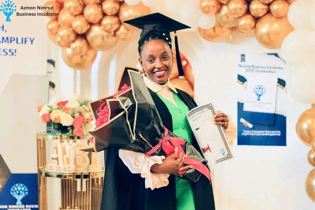 Graduates in caps and gowns celebrating at the ANBI graduation ceremony