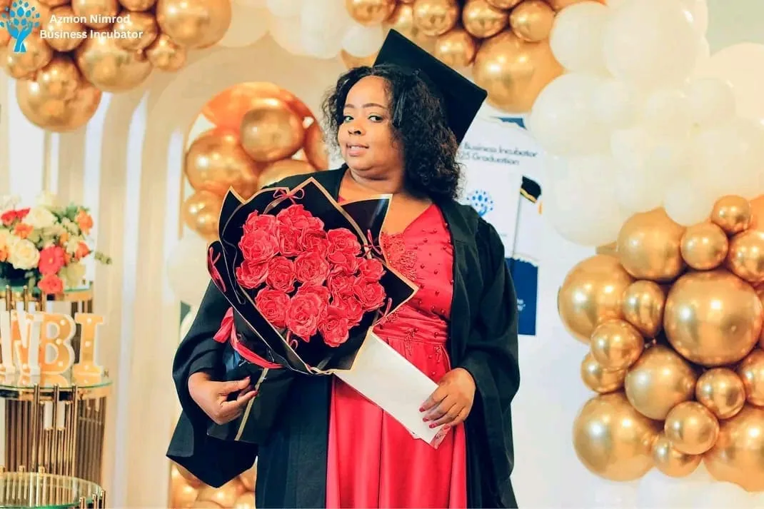 Graduates in caps and gowns celebrating at the ANBI graduation ceremony