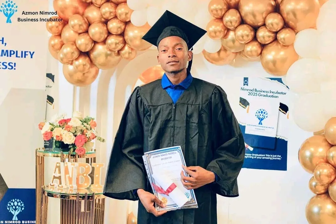 Graduates in caps and gowns celebrating at the ANBI graduation ceremony