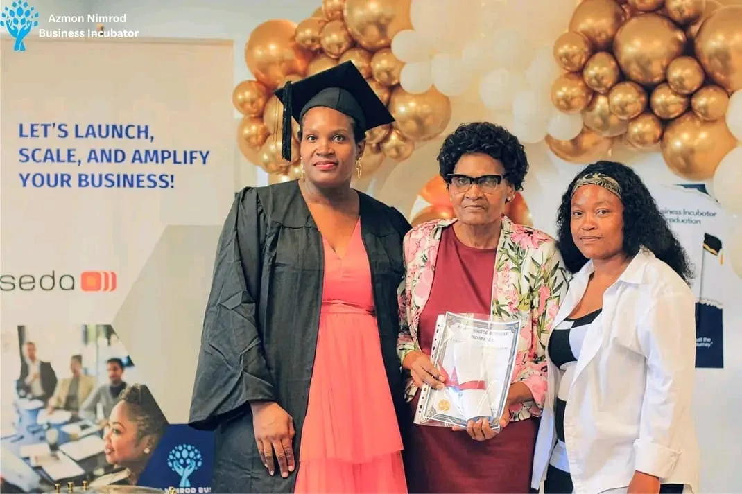 Graduates in caps and gowns celebrating at the ANBI graduation ceremony
