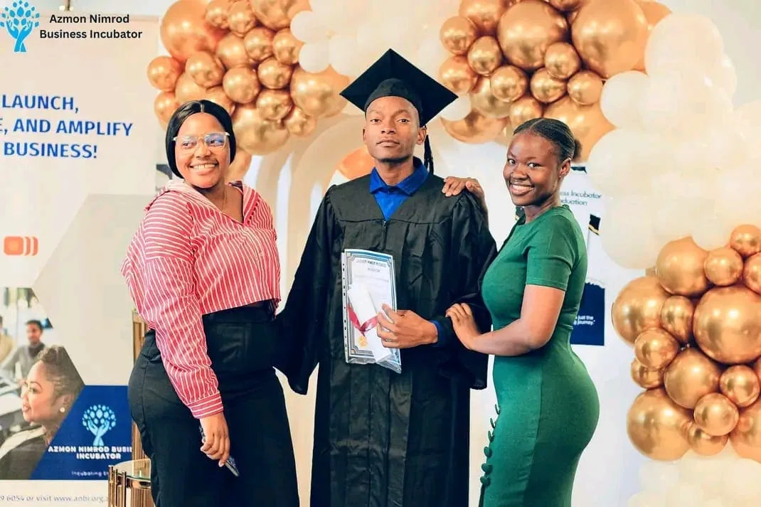 Graduates in caps and gowns celebrating at the ANBI graduation ceremony
