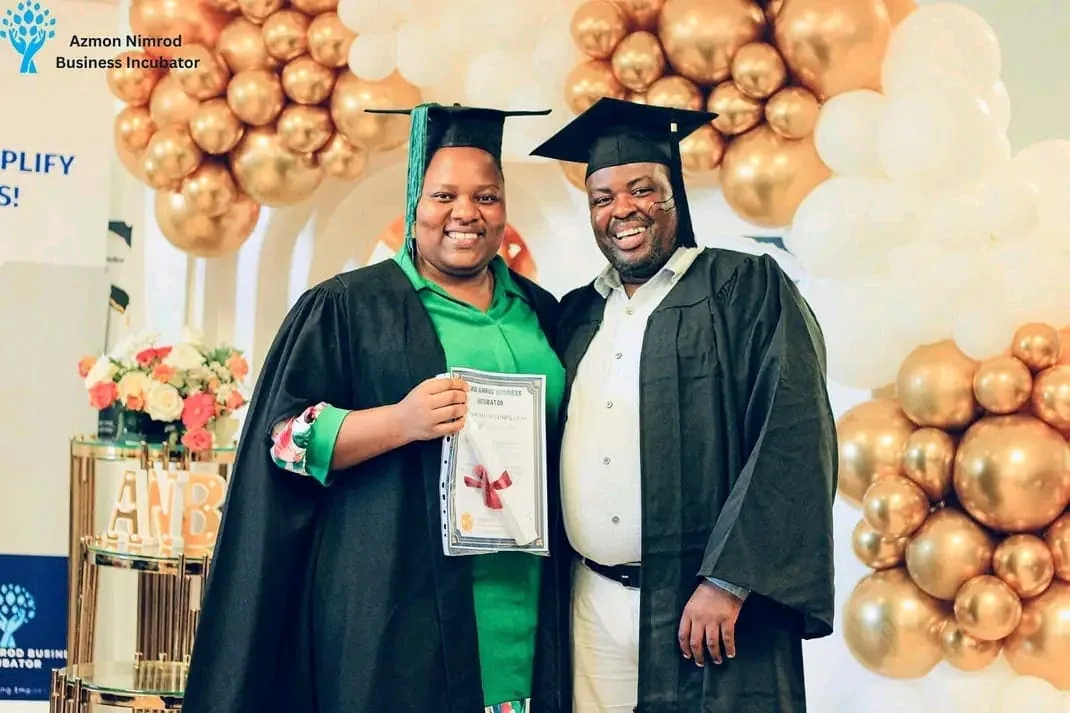 Graduates in caps and gowns celebrating at the ANBI graduation ceremony