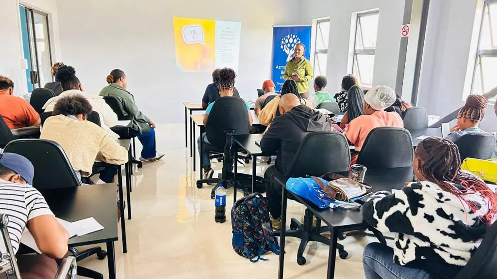 A facilitator addressing a full room of 2026 incubatees