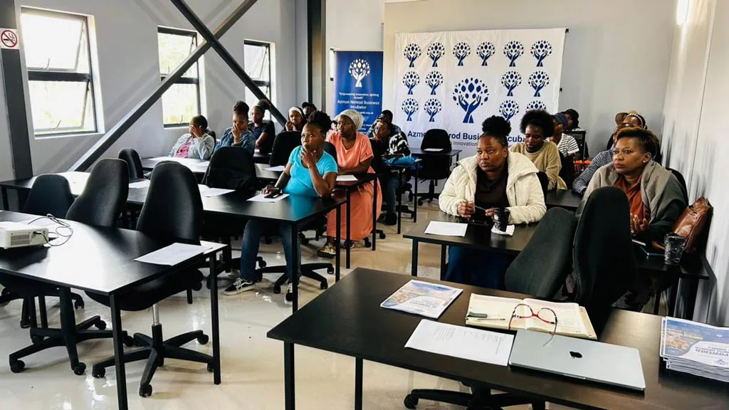 Incubatees in a training session in front of the ANBI branded backdrop