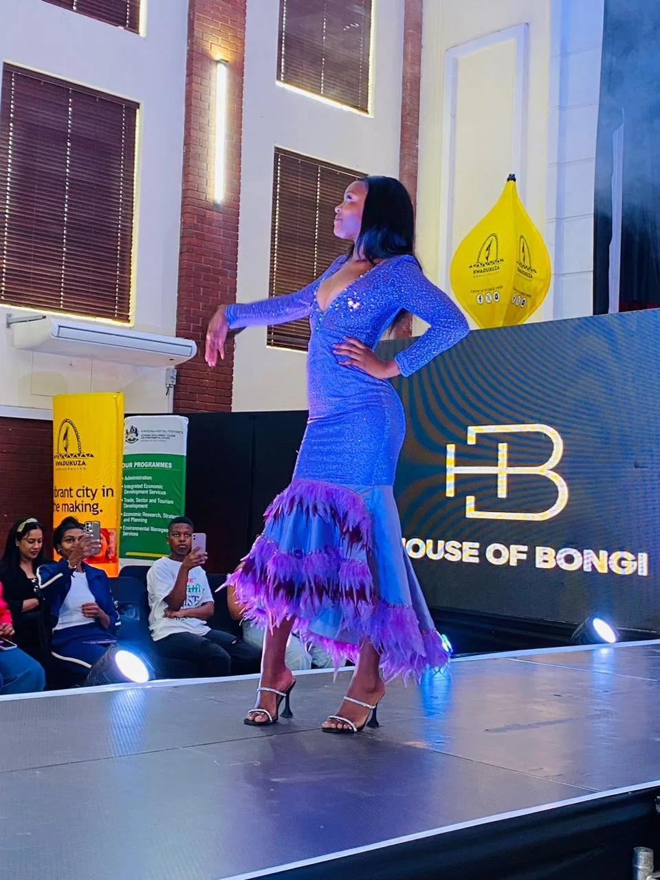 A model in a blue mermaid-cut gown on the House of Bongi runway