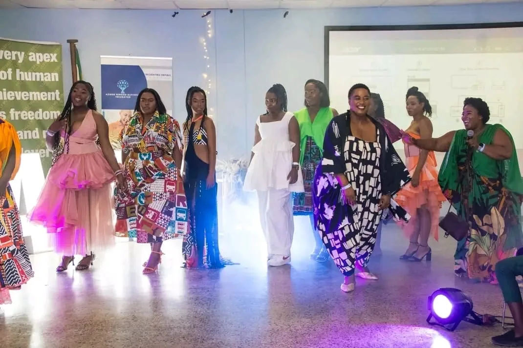 The full line-up of models on stage under the lights at the finale